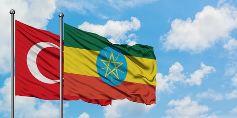 Turkey and Ethiopia flag waving in the wind against white cloudy blue sky together. Diplomacy...