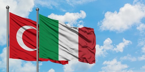 Turkey and Italy flag waving in the wind against white cloudy blue sky together. Diplomacy concept,...