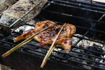 South East Asian Food. Grilled chicken. Grilled BBQ Chicken. Barbecued chicken on charcoal stove. Street food Asian