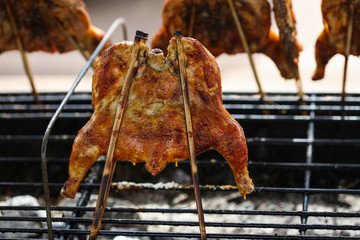 Grilled chicken. Grilled BBQ Chicken. Barbecued chicken on charcoal stove. Street food 
