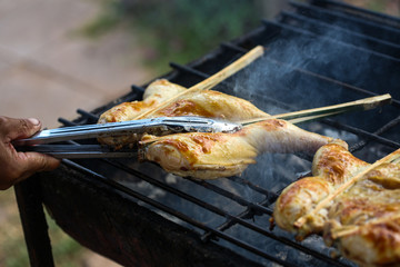 South East Asian Food. Grilled chicken. Grilled BBQ Chicken. Barbecued chicken on charcoal stove. Street food Asian