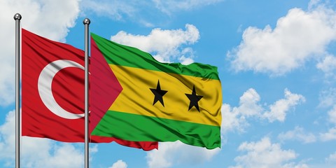 Turkey and Sao Tome And Principe flag waving in the wind against white cloudy blue sky together. Diplomacy concept, international relations.