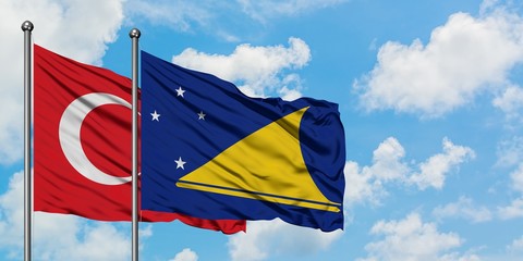 Turkey and Tokelau flag waving in the wind against white cloudy blue sky together. Diplomacy concept, international relations.