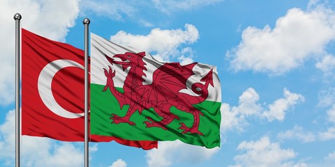 Turkey and Wales flag waving in the wind against white cloudy blue sky together. Diplomacy concept,...