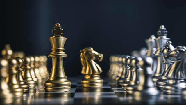 Close-up of gold and silver team chess board game