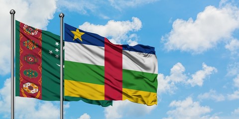 Turkmenistan and Central African Republic flag waving in the wind against white cloudy blue sky...