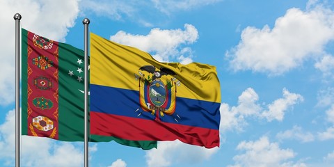 Turkmenistan and Ecuador flag waving in the wind against white cloudy blue sky together. Diplomacy concept, international relations.