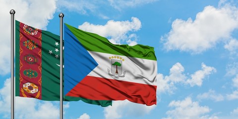 Turkmenistan and Equatorial Guinea flag waving in the wind against white cloudy blue sky together. Diplomacy concept, international relations.