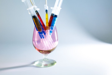 Set of medical syringes in a glass with colored injections for cosmetology. The concept of cosmetology by various infections