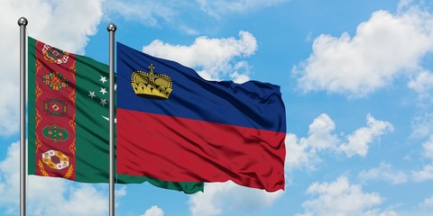 Turkmenistan and Liechtenstein flag waving in the wind against white cloudy blue sky together. Diplomacy concept, international relations.