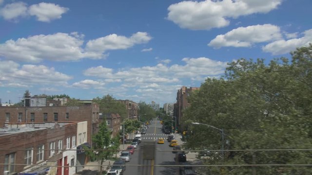 handheld shot of brooklyn roofs through subways windows