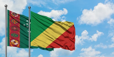 Turkmenistan and Republic Of The Congo flag waving in the wind against white cloudy blue sky together. Diplomacy concept, international relations.