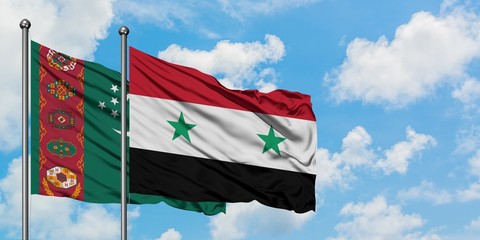 Turkmenistan and Syria flag waving in the wind against white cloudy blue sky together. Diplomacy...