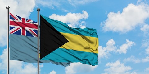 Tuvalu and Bahamas flag waving in the wind against white cloudy blue sky together. Diplomacy concept, international relations.