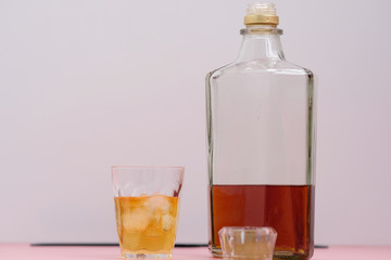 glass of whiskey and ice on wooden table