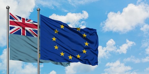 Tuvalu and European Union flag waving in the wind against white cloudy blue sky together. Diplomacy concept, international relations.