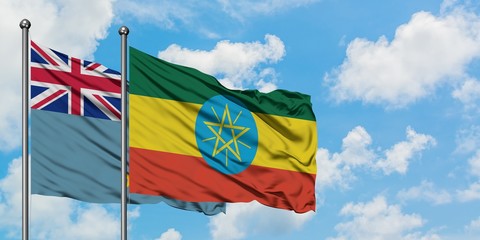 Tuvalu and Ethiopia flag waving in the wind against white cloudy blue sky together. Diplomacy...