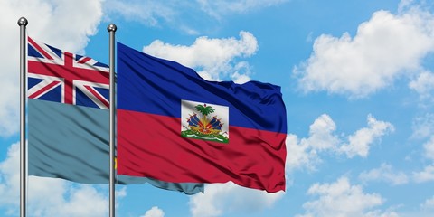 Tuvalu and Haiti flag waving in the wind against white cloudy blue sky together. Diplomacy concept, international relations.