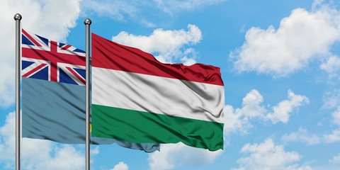 Tuvalu and Hungary flag waving in the wind against white cloudy blue sky together. Diplomacy concept, international relations.