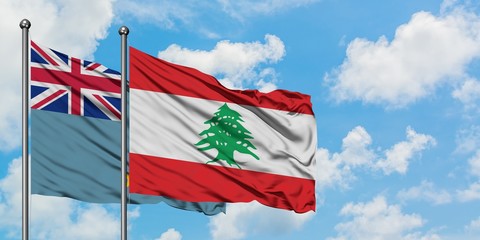 Tuvalu and Lebanon flag waving in the wind against white cloudy blue sky together. Diplomacy concept, international relations.