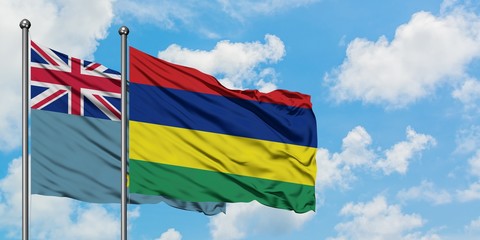 Tuvalu and Mauritius flag waving in the wind against white cloudy blue sky together. Diplomacy concept, international relations.