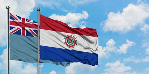 Tuvalu and Paraguay flag waving in the wind against white cloudy blue sky together. Diplomacy concept, international relations.