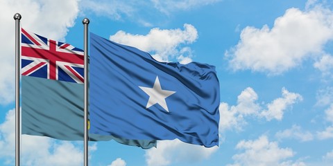 Tuvalu and Somalia flag waving in the wind against white cloudy blue sky together. Diplomacy...