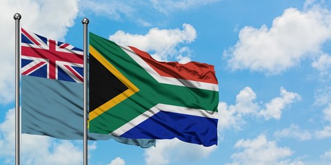 Tuvalu and South Africa flag waving in the wind against white cloudy blue sky together. Diplomacy concept, international relations.