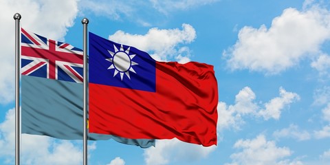 Tuvalu and Taiwan flag waving in the wind against white cloudy blue sky together. Diplomacy...