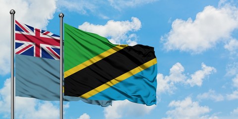 Tuvalu and Tanzania flag waving in the wind against white cloudy blue sky together. Diplomacy concept, international relations.