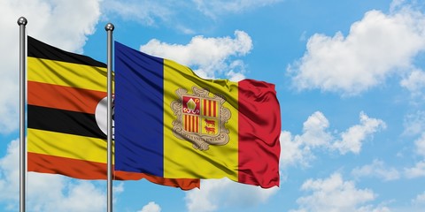 Uganda and Andorra flag waving in the wind against white cloudy blue sky together. Diplomacy concept, international relations.