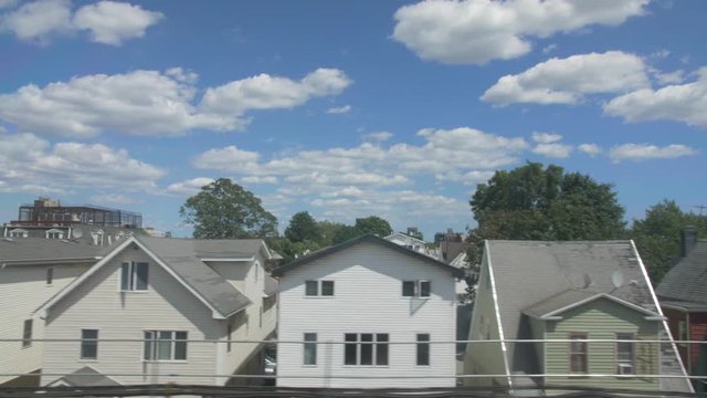 handheld shot of brooklyn houses through subways windows