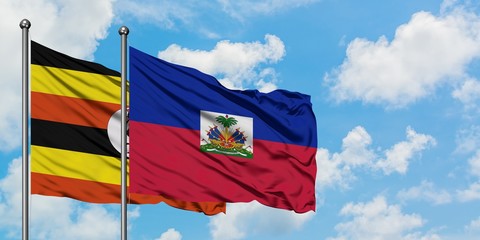 Uganda and Haiti flag waving in the wind against white cloudy blue sky together. Diplomacy concept, international relations.