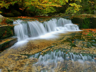 Waterfalls cascade in autumn forest. Beautiful colors of nature