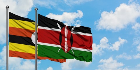 Uganda and Kenya flag waving in the wind against white cloudy blue sky together. Diplomacy concept, international relations.