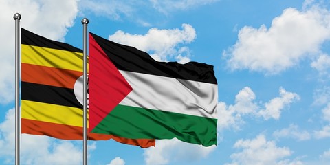 Uganda and Palestine flag waving in the wind against white cloudy blue sky together. Diplomacy concept, international relations.