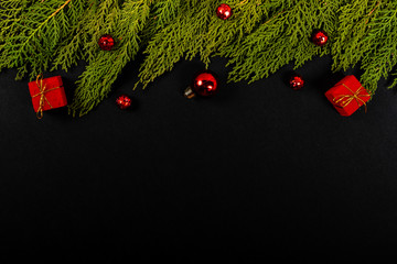 Christmas composition. Girlanda with red Christmas ornaments on black background. Christmas, winter, new year concept. Flat lay, top view, copy space. © Julio Ricco