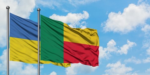 Ukraine and Benin flag waving in the wind against white cloudy blue sky together. Diplomacy concept, international relations.