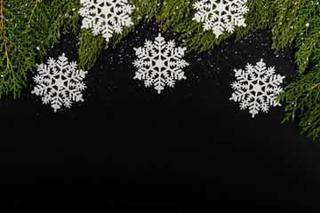 Christmas composition. Girlanda with drops and snow on black background. Christmas, winter, new year concept. Flat lay, top view, copy space. © Julio Ricco