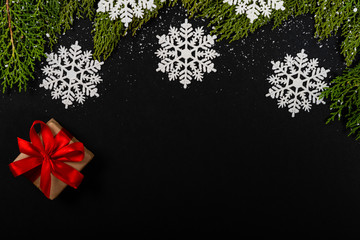 Christmas composition. Girlanda with drops and snow on black background. Christmas, winter, new year concept. Flat lay, top view, copy space. © Julio Ricco