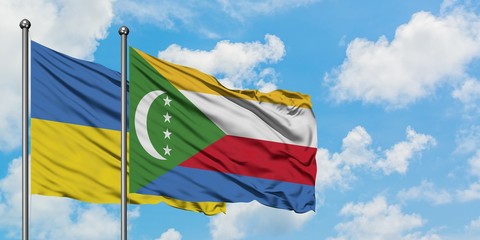 Ukraine and Comoros flag waving in the wind against white cloudy blue sky together. Diplomacy concept, international relations.