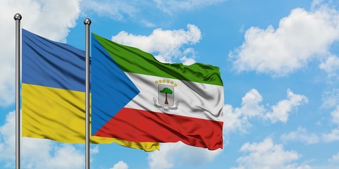 Ukraine and Equatorial Guinea flag waving in the wind against white cloudy blue sky together. Diplomacy concept, international relations.