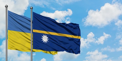 Ukraine and Nauru flag waving in the wind against white cloudy blue sky together. Diplomacy concept, international relations.