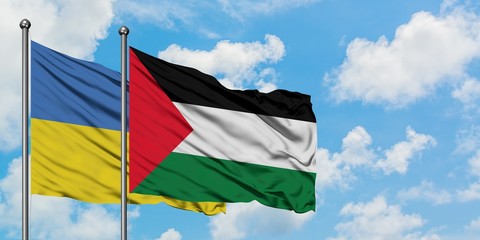 Ukraine and Palestine flag waving in the wind against white cloudy blue sky together. Diplomacy concept, international relations.