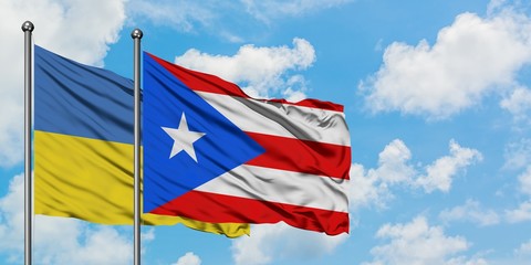 Ukraine and Puerto Rico flag waving in the wind against white cloudy blue sky together. Diplomacy concept, international relations.