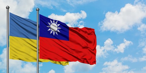 Ukraine and Taiwan flag waving in the wind against white cloudy blue sky together. Diplomacy concept, international relations.