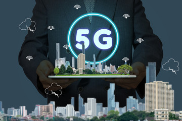 5G network interface and icon concept,businessman holding a tablet with city model in hands