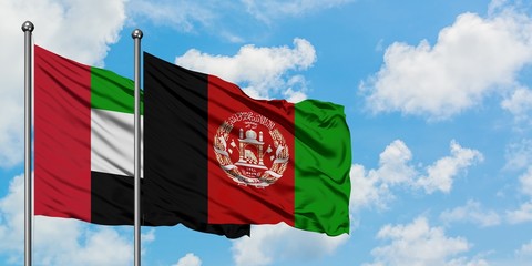 United Arab Emirates and Afghanistan flag waving in the wind against white cloudy blue sky together. Diplomacy concept, international relations.