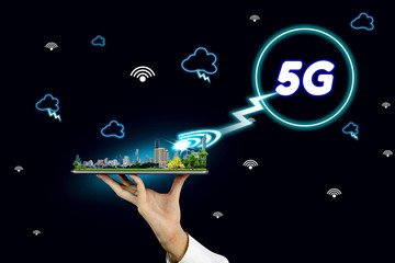 5G network interface and icon concept,businessman holding a tablet with city model in hands