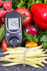 Glucometer with sugar level and fresh vegetables as food as source vitamins. Healthy lifestyles and nutrition